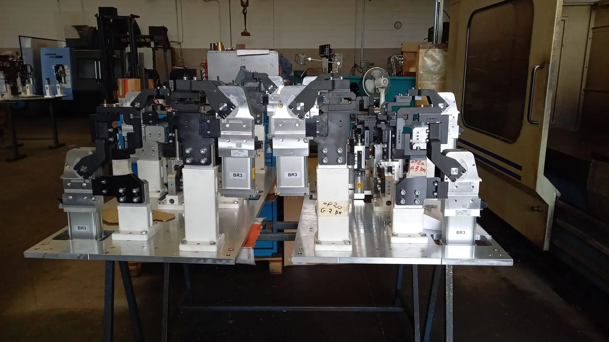 Automotive welding fixture mounted on an aluminium plate, with pneumatic clamps in a row